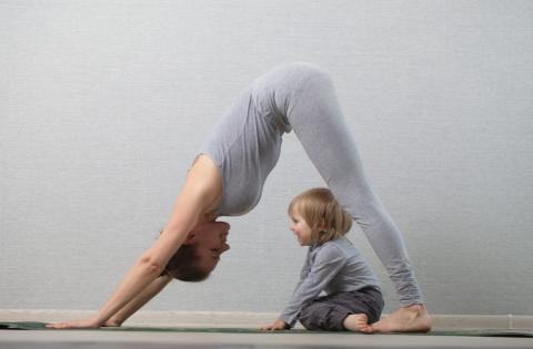 woman and toddler doing yoga together